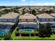 Aerial view showcases the home's pool, screened lanai, landscaping, and tile roof at 9023 Shadow Mountain St, Davenport, FL 33896