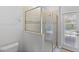 Tiled bathroom features glass enclosed shower, neutral colors, and access to the lanai at 9023 Shadow Mountain St, Davenport, FL 33896