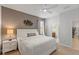 Comfortable bedroom with a queen bed, modern wall decor, and ensuite bath access at 9023 Shadow Mountain St, Davenport, FL 33896