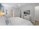 Bright bedroom featuring a large bed, TV, ceiling fan, and ensuite bathroom at 9023 Shadow Mountain St, Davenport, FL 33896