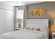 Comfortable bedroom with a queen bed, modern wall decor, and an abundance of natural light at 9023 Shadow Mountain St, Davenport, FL 33896