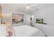 Tranquil bedroom features a queen bed, dresser with television, and neutral wall art at 9023 Shadow Mountain St, Davenport, FL 33896