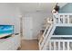 Playful bunk bedroom featuring a TV and a view into the hall at 9023 Shadow Mountain St, Davenport, FL 33896