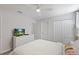 Bright bedroom with a queen bed, dresser with television, and a ceiling fan at 9023 Shadow Mountain St, Davenport, FL 33896