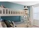 Cozy bunk bedroom with white bunk beds and bright accent wall at 9023 Shadow Mountain St, Davenport, FL 33896