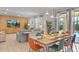 Open-concept dining area featuring a large table, modern lighting, and seamless access to outdoor pool at 9023 Shadow Mountain St, Davenport, FL 33896