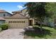 Charming two-story home featuring a tile roof, brick driveway, and well-maintained landscaping at 9023 Shadow Mountain St, Davenport, FL 33896