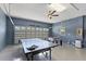Multi-purpose garage with ping pong table, foosball, ceiling fan, and epoxy floor at 9023 Shadow Mountain St, Davenport, FL 33896