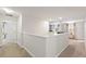 A light-filled hallway with neutral carpet leads to other rooms in the home at 9023 Shadow Mountain St, Davenport, FL 33896