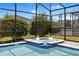 This covered outdoor jacuzzi is surrounded by lush landscaping and is equipped with jets at 9023 Shadow Mountain St, Davenport, FL 33896