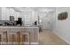Bright kitchen features white cabinets, stainless steel appliances, granite countertops and a breakfast bar at 9023 Shadow Mountain St, Davenport, FL 33896