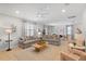 Spacious living area flows into the dining area, featuring comfortable sofas and neutral tones at 9023 Shadow Mountain St, Davenport, FL 33896