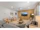 Open living room showcasing a flat-screen TV, comfortable seating, and modern decorative elements at 9023 Shadow Mountain St, Davenport, FL 33896