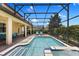 Relax by your private screened pool and hot tub surrounded by a brick paver deck and lush landscaping at 9023 Shadow Mountain St, Davenport, FL 33896
