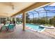 Screened-in lanai features a pool, hot tub, lounge chairs, and dining area, perfect for outdoor enjoyment at 9023 Shadow Mountain St, Davenport, FL 33896