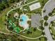 Overhead shot of a community pool, putting green, sand volleyball court and clubhouse in a well-maintained neighborhood at 9128 Sonoma Coast Dr, Winter Garden, FL 34787