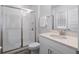 Bathroom featuring a single sink vanity, glass enclosed shower with tile, and wood look flooring at 9128 Sonoma Coast Dr, Winter Garden, FL 34787