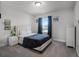 A bedroom with plush carpet, a queen bed, and a window with curtains for natural light at 9128 Sonoma Coast Dr, Winter Garden, FL 34787