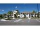 Exterior view of the community clubhouse with parking, meticulously landscaped for a welcoming entrance at 9128 Sonoma Coast Dr, Winter Garden, FL 34787