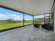Relaxing covered patio with comfortable seating overlooking a lush green backyard and tranquil water view at 9128 Sonoma Coast Dr, Winter Garden, FL 34787