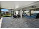 Spacious covered patio with comfortable seating, ceiling fan, and a scenic backyard view at 9128 Sonoma Coast Dr, Winter Garden, FL 34787