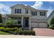 Beautiful two-story home with a landscaped front yard, attached two-car garage, and covered entryway at 9128 Sonoma Coast Dr, Winter Garden, FL 34787