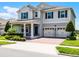 Charming two-story home featuring a quaint front porch, a brick driveway and a two car garage at 9128 Sonoma Coast Dr, Winter Garden, FL 34787