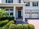 Charming home exterior with blue door, well-manicured landscaping, and two-car garage at 9128 Sonoma Coast Dr, Winter Garden, FL 34787