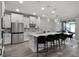 Open-concept kitchen with stainless appliances, breakfast bar, tile backsplash, and bright, airy dining area at 9128 Sonoma Coast Dr, Winter Garden, FL 34787