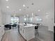 Open concept kitchen with stainless steel appliances, a central island, and views into the living and dining areas at 9128 Sonoma Coast Dr, Winter Garden, FL 34787