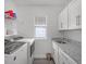 Bright laundry room with washer, dryer, sink, and cabinets at 9128 Sonoma Coast Dr, Winter Garden, FL 34787