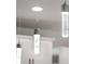 Modern pendant lights hanging above a kitchen island, offering stylish illumination to the space at 9128 Sonoma Coast Dr, Winter Garden, FL 34787