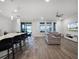 Open-concept living space with kitchen bar, cozy sofa, and sliding doors to outdoor patio at 9128 Sonoma Coast Dr, Winter Garden, FL 34787