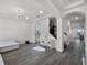 Spacious living area showcasing open floor plan, staircase, and white furniture at 9128 Sonoma Coast Dr, Winter Garden, FL 34787