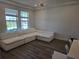 Bright and airy living room with a large sectional couch, hardwood floors, and ample natural light at 9128 Sonoma Coast Dr, Winter Garden, FL 34787