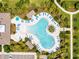 Aerial view of tropical swimming pool with ample seating, palms, and umbrellas at 9128 Sonoma Coast Dr, Winter Garden, FL 34787