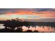 A breathtaking sunset view with colorful clouds reflecting off a calm lake at dusk at 9128 Sonoma Coast Dr, Winter Garden, FL 34787