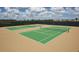 Two tennis courts enclosed by fencing and netting, painted in green and tan, for community use at 9128 Sonoma Coast Dr, Winter Garden, FL 34787