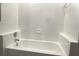 Bathroom features a bathtub with tiled walls and built in soap dish at 926 Freshmeadow Ct, Apopka, FL 32703
