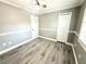 Bedroom with gray walls, white trim, ceiling fan, and wood-look flooring at 926 Freshmeadow Ct, Apopka, FL 32703