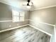 This bedroom offers wood-look flooring, a ceiling fan, and a shuttered window at 926 Freshmeadow Ct, Apopka, FL 32703