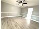 Bedroom featuring modern gray walls, crown molding, light wood-look flooring, and natural light at 926 Freshmeadow Ct, Apopka, FL 32703