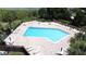 A sparkling blue pool is surrounded by patio seating at 926 Freshmeadow Ct, Apopka, FL 32703