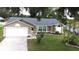 Inviting single-Gathering home with a well-kept lawn, mature landscaping, and a two-car garage at 926 Freshmeadow Ct, Apopka, FL 32703