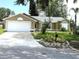 Charming one-story home with a white garage door, a well-maintained lawn, and front yard landscaping at 926 Freshmeadow Ct, Apopka, FL 32703