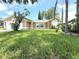 Well-maintained house with manicured lawn and mature trees in the front yard at 926 Freshmeadow Ct, Apopka, FL 32703