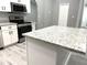 Kitchen featuring granite countertops, stainless steel appliances, white cabinets, and an island at 926 Freshmeadow Ct, Apopka, FL 32703