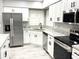 Spacious kitchen featuring stainless steel appliances, white cabinets and granite countertops at 926 Freshmeadow Ct, Apopka, FL 32703