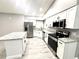 Bright kitchen with white cabinetry, granite countertops, stainless steel appliances, and an island at 926 Freshmeadow Ct, Apopka, FL 32703