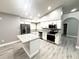 Well-lit kitchen features stainless steel appliances, granite counters and a large center island at 926 Freshmeadow Ct, Apopka, FL 32703